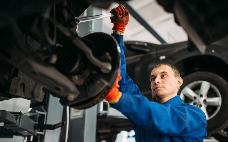 mechanic performing suspension repair of a car in minneapolis